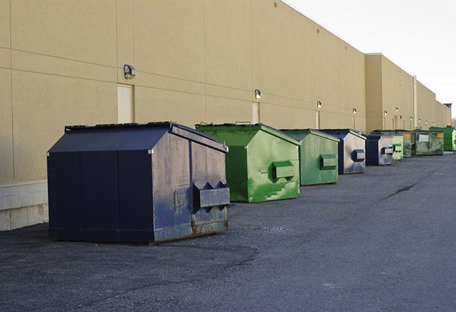 a row of heavy-duty dumpsters ready for use at a construction project in Bronxville, NY